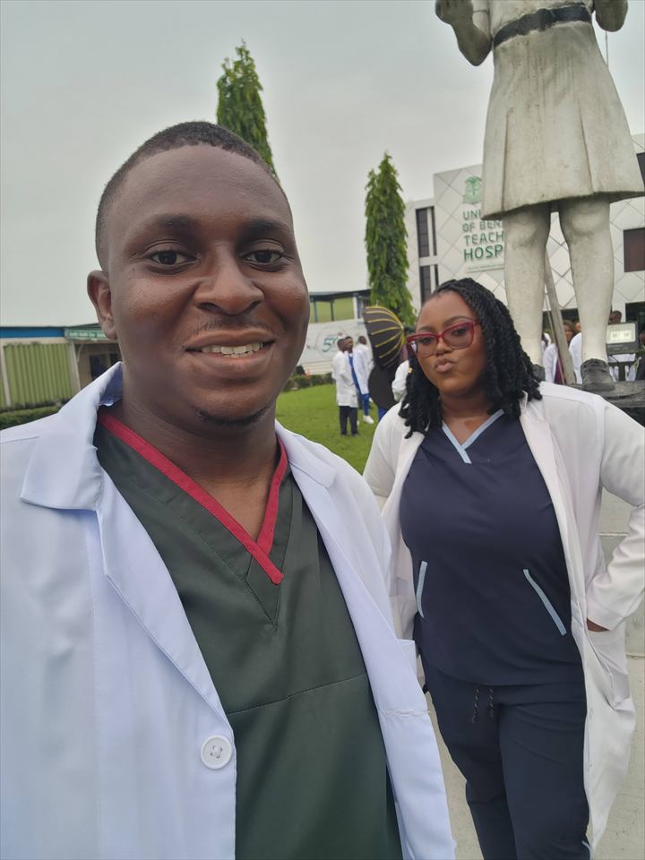 Osaro and Achi wearing scrubs and white coats at the University of Benin Teaching Hospital