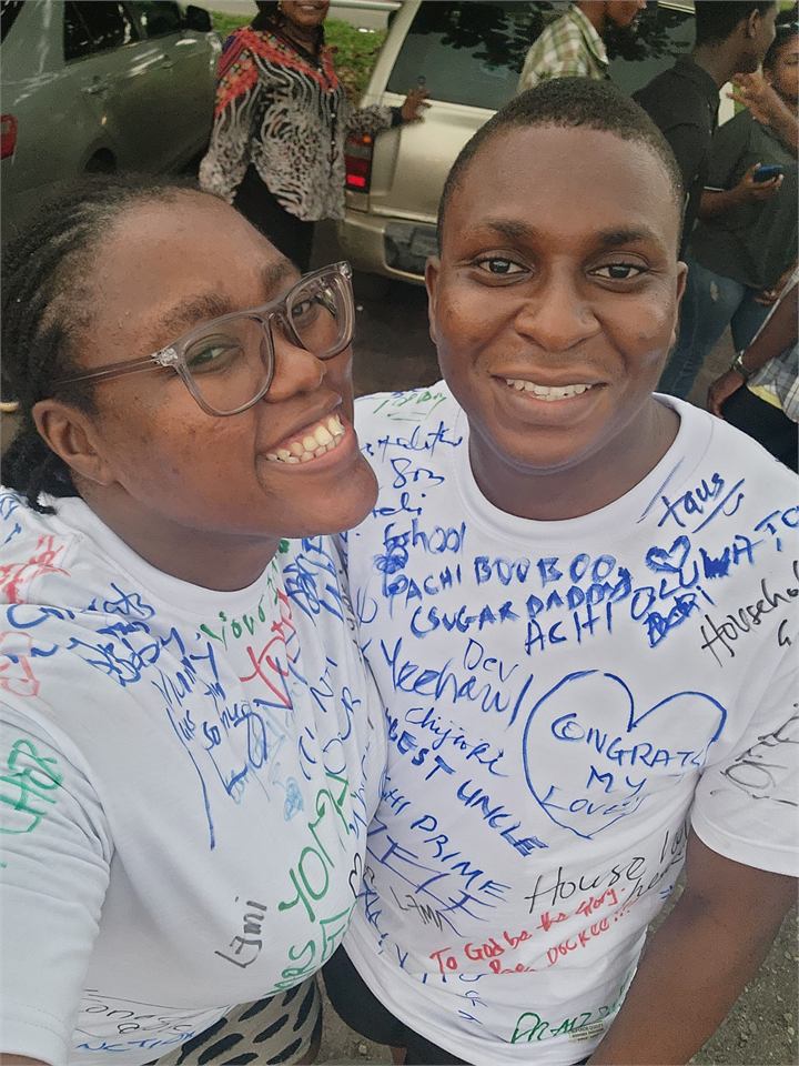 Osaro and Achi smiling together in their signed Signout shirts