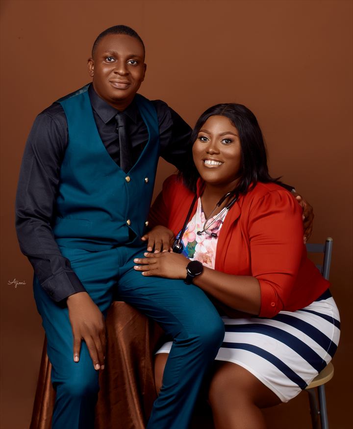 Osaro and Achi seated together in a professional studio portrait