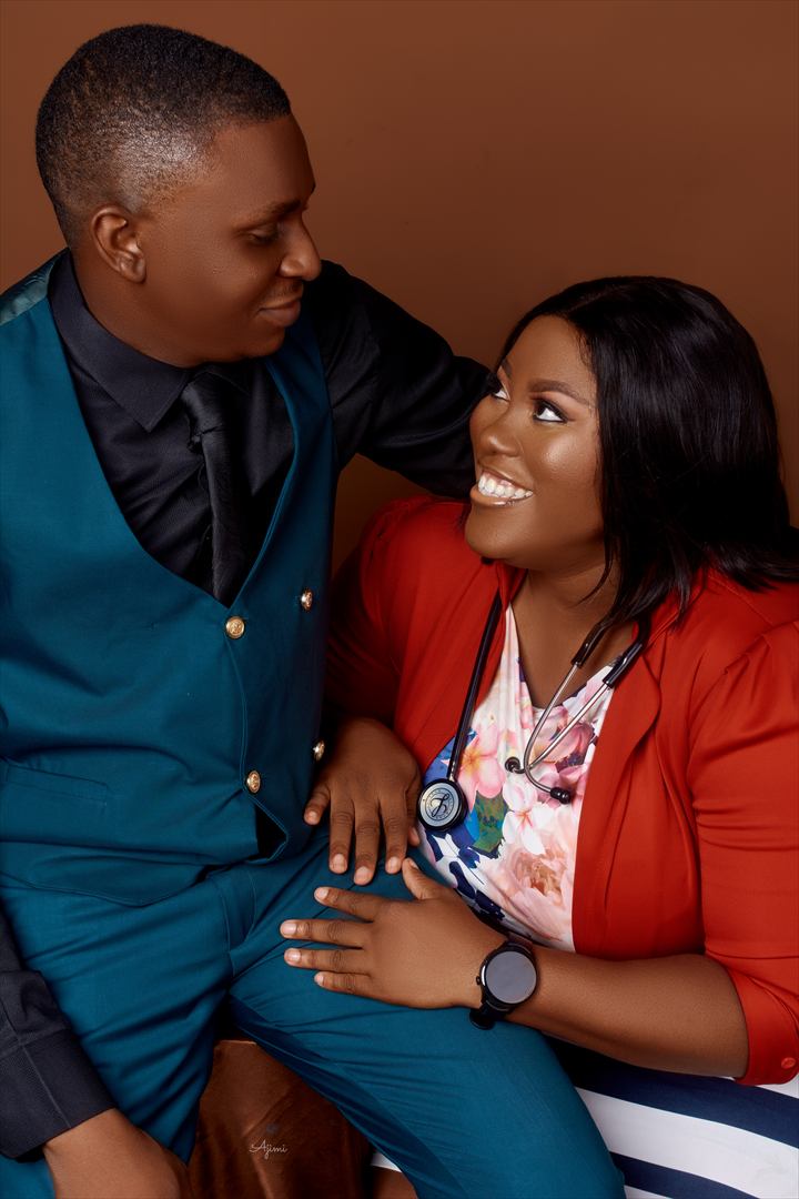 Osaro and Achi smiling at one another in a studio portrait