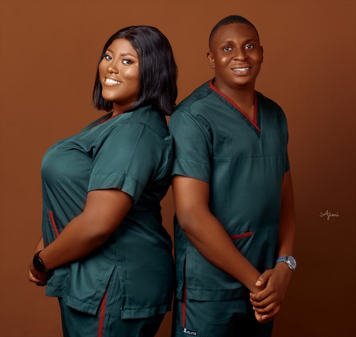 Osaro and Achi standing back to back in matching medical scrubs