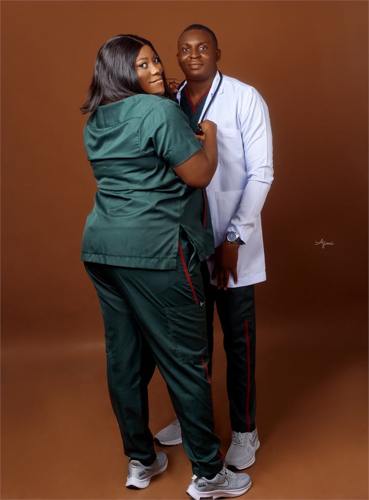 Osaro and Achi posing together in medical scrubs and a white coat