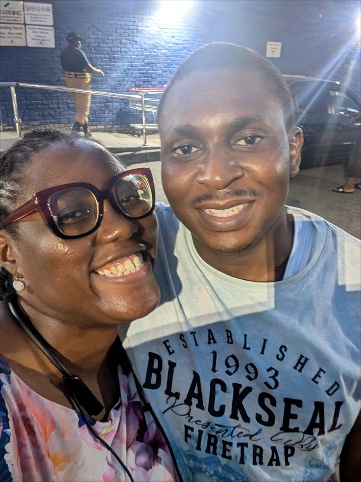 Osaro and Achi smiling together in an evening selfie