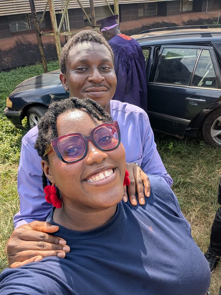 Osaro and Achi taking a selfie at a graduation ceremony