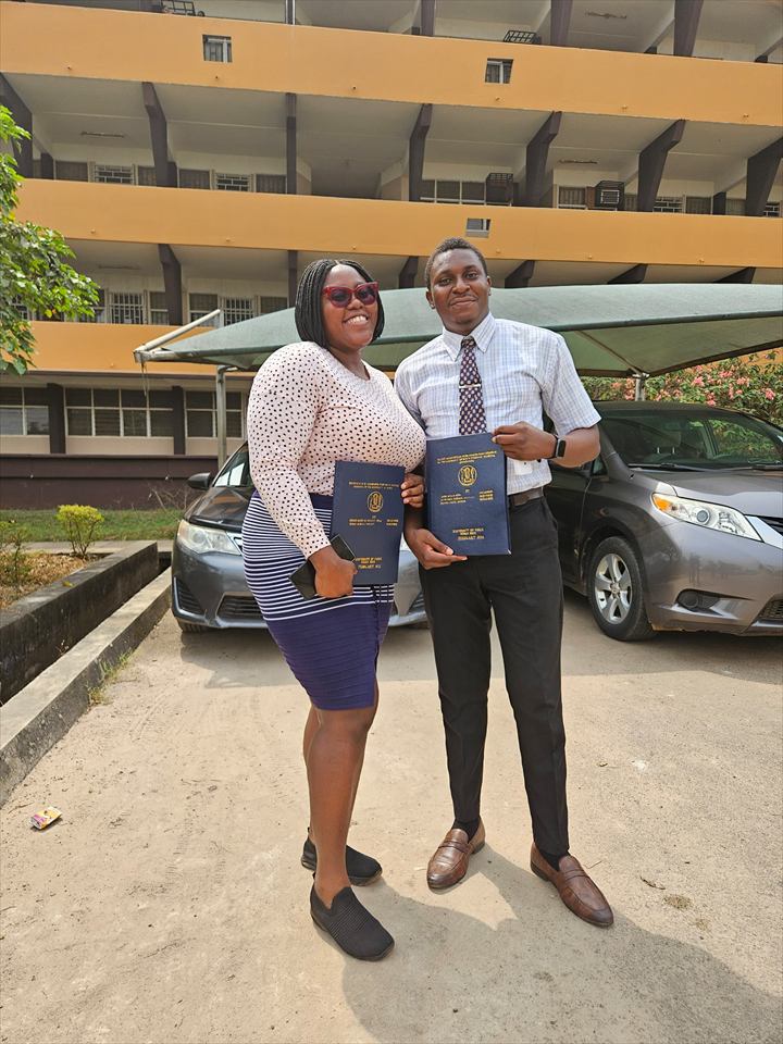 Osaro and Achi holding their degree certificates together