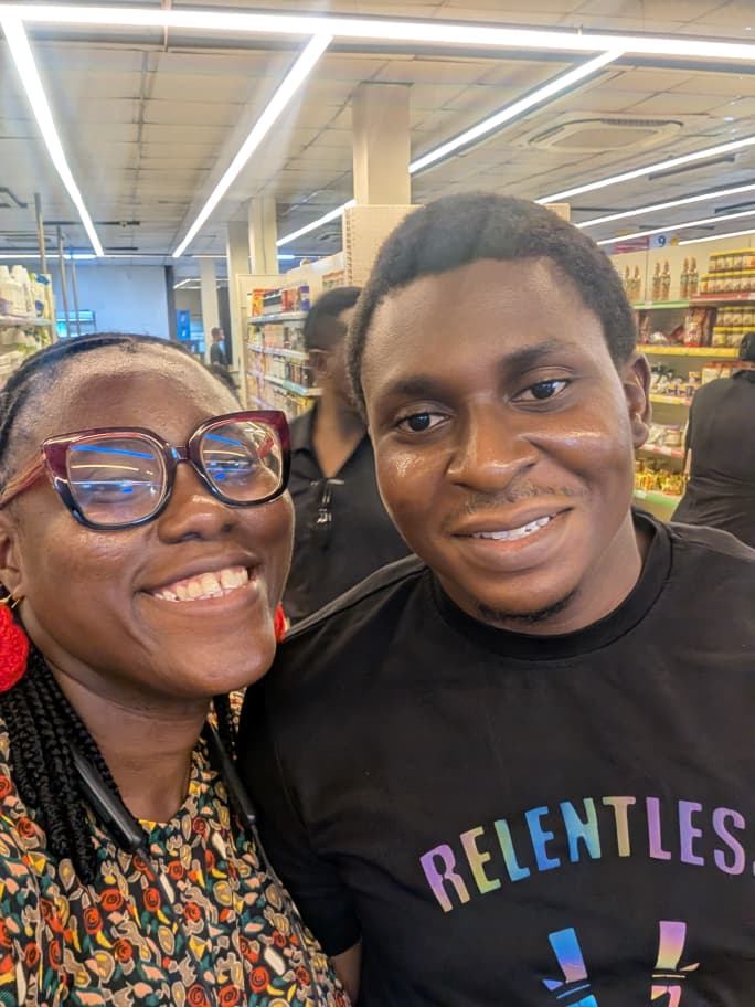 Osaro and Achi smiling together during a supermarket trip