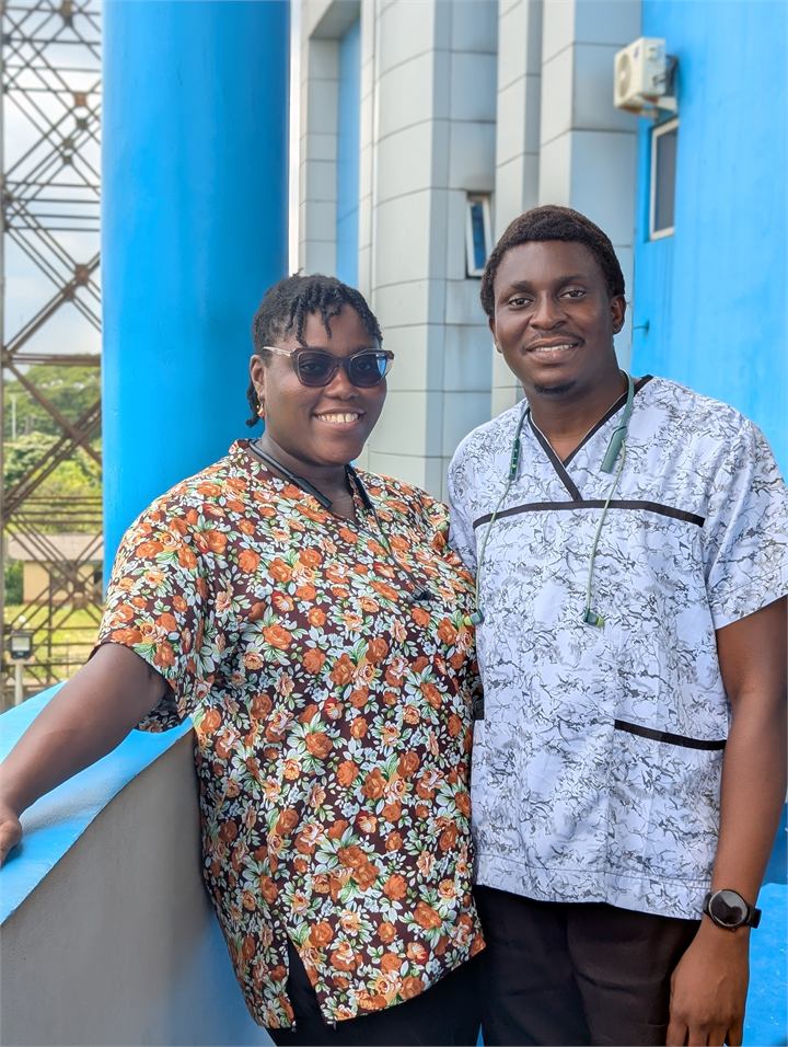 Osaro and Achi standing together in patterned medical scrubs